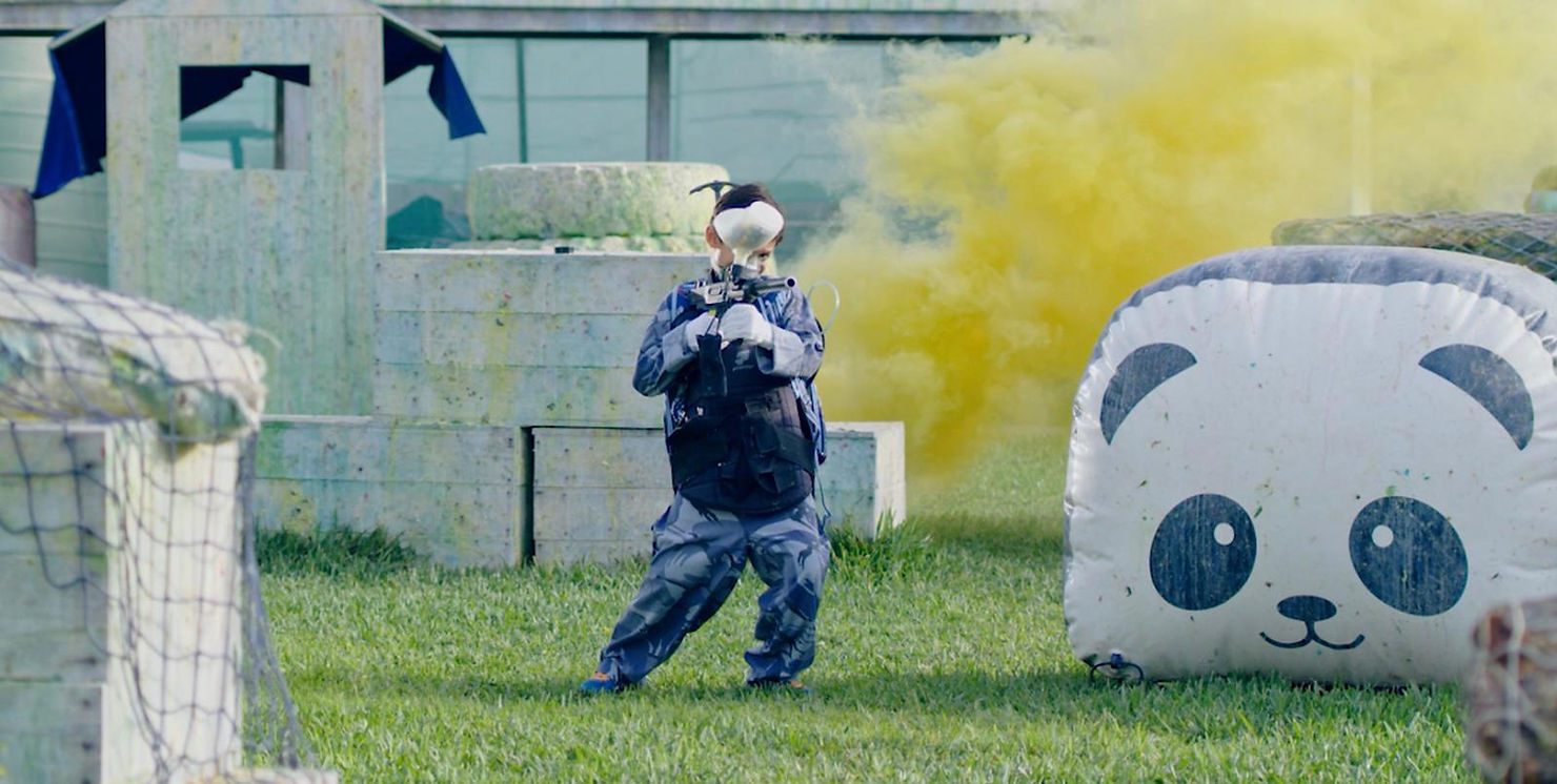 A person standing in front of a beautiful mountain view captured in a full shot.